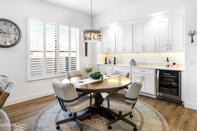 dining room with a chandelier, beverage cooler, and dark wood-type flooring