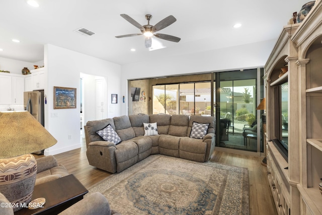 living room with ceiling fan and wood-type flooring