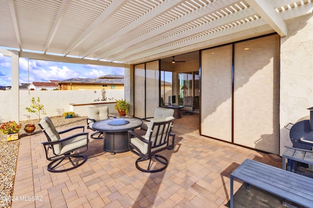 view of patio with a pergola and a fire pit