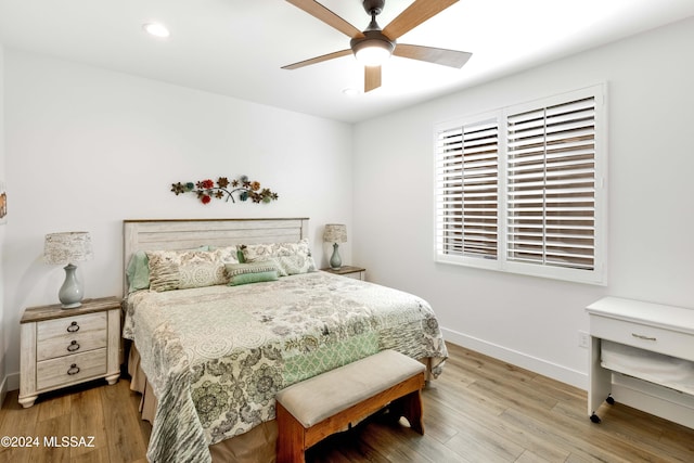 bedroom with ceiling fan and wood-type flooring