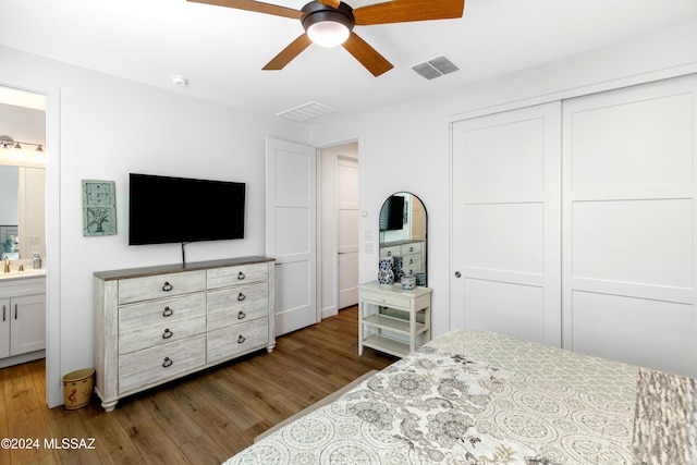 bedroom with connected bathroom, ceiling fan, a closet, and dark hardwood / wood-style floors