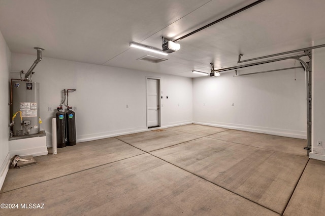 garage featuring gas water heater and a garage door opener