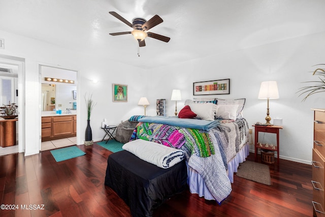 bedroom with ceiling fan, dark hardwood / wood-style flooring, and connected bathroom