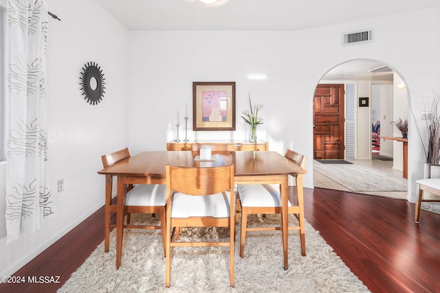 dining space with hardwood / wood-style flooring