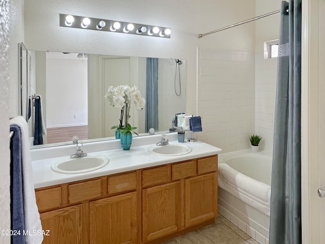 bathroom with vanity, shower / tub combo with curtain, and tile patterned floors