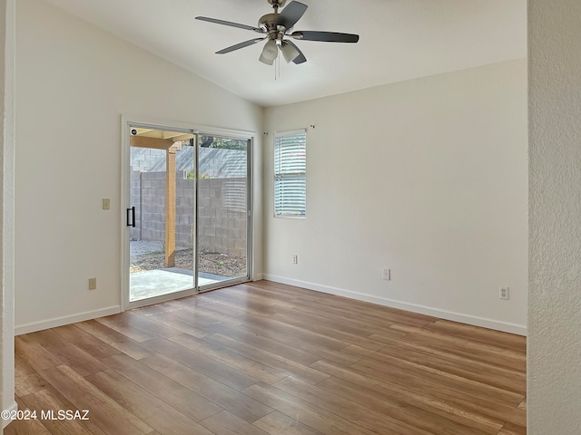 empty room featuring ceiling fan, lofted ceiling, and light wood-type flooring