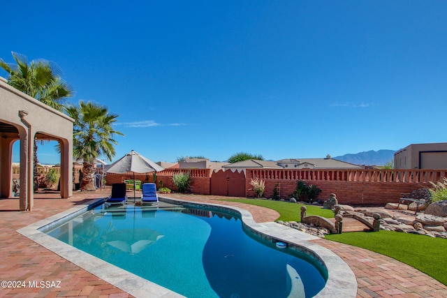 view of pool with a mountain view and a patio area