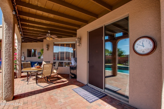 view of patio featuring a fenced in pool and ceiling fan