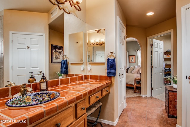 bathroom with tile patterned flooring and vanity