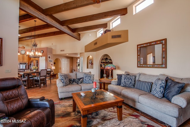 tiled living room with beamed ceiling, a towering ceiling, and an inviting chandelier