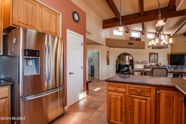 kitchen with beam ceiling, an inviting chandelier, stainless steel fridge, pendant lighting, and light tile patterned floors