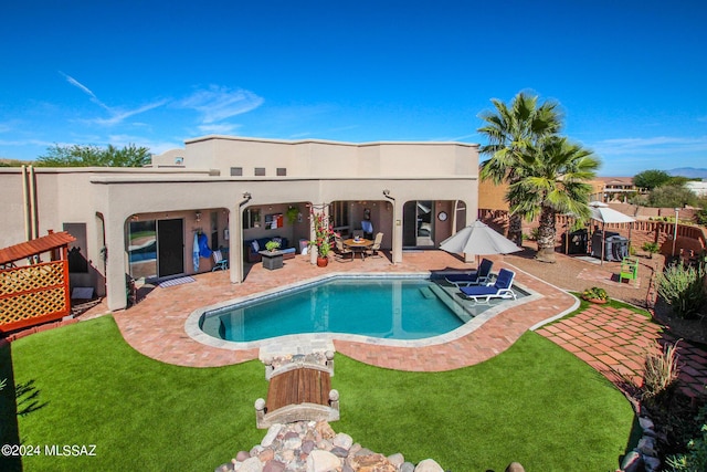 view of swimming pool with a lawn and a patio