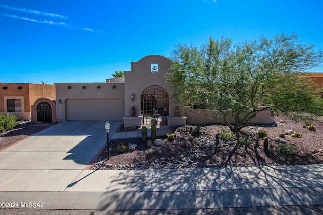 pueblo-style house with a garage