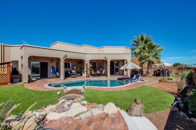 view of pool with a patio area and a yard