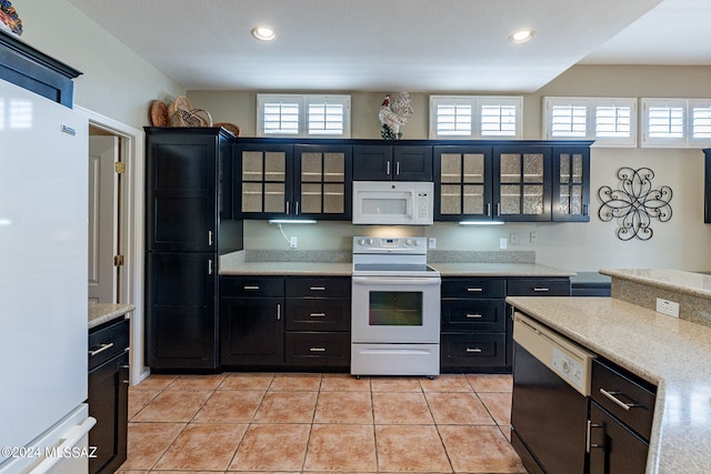 kitchen featuring light tile patterned floors and white appliances