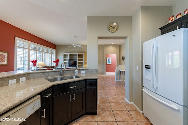 kitchen featuring sink, light tile patterned flooring, white refrigerator with ice dispenser, stainless steel dishwasher, and ceiling fan