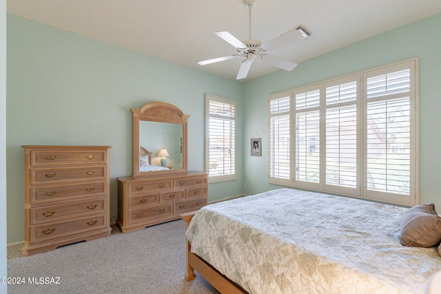 bedroom featuring light carpet and ceiling fan