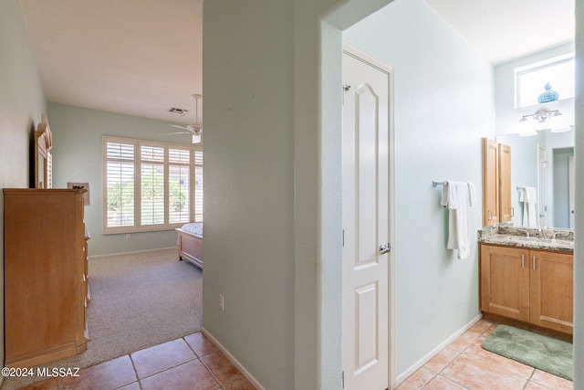 bathroom featuring vanity, ceiling fan, tile patterned flooring, and plenty of natural light