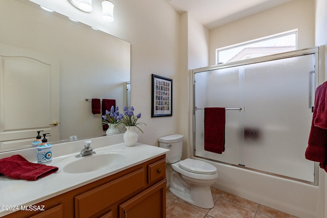 full bathroom with vanity, enclosed tub / shower combo, toilet, and tile patterned floors