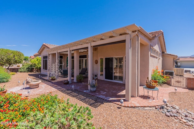 rear view of house featuring central AC and a patio area