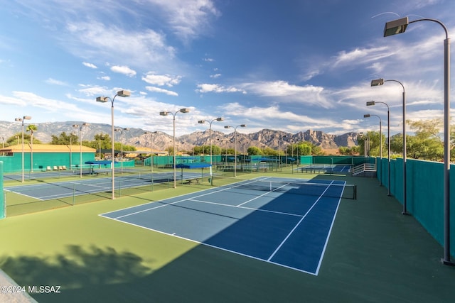 view of tennis court featuring a mountain view