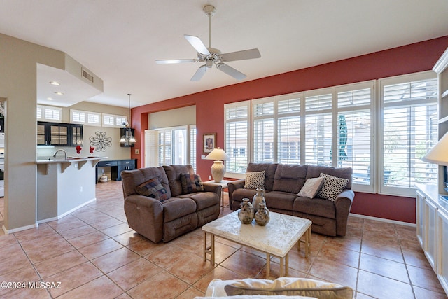 living room with ceiling fan, sink, plenty of natural light, and light tile patterned floors