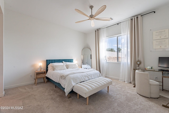 bedroom featuring baseboards, a ceiling fan, and light colored carpet