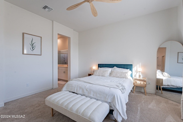 bedroom featuring arched walkways, visible vents, light carpet, and baseboards