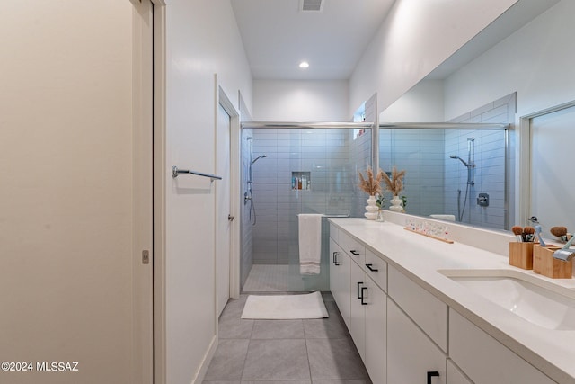 full bathroom featuring visible vents, a stall shower, tile patterned flooring, and vanity