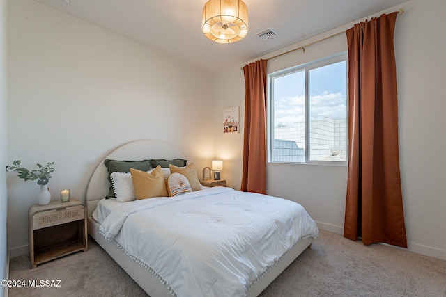 bedroom with carpet floors, lofted ceiling, visible vents, and baseboards