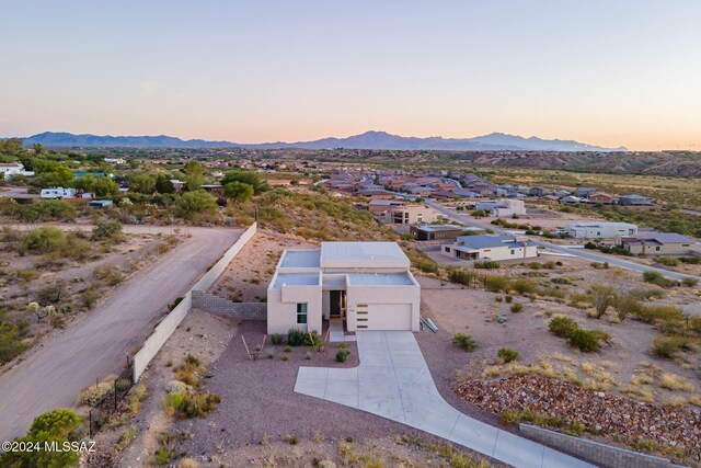 pueblo revival-style home featuring a garage