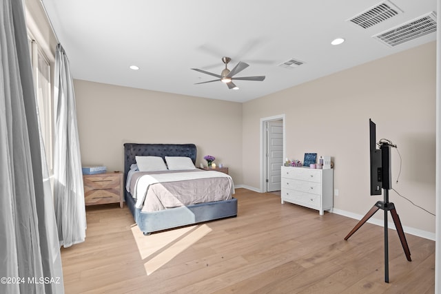 bedroom with light hardwood / wood-style flooring and ceiling fan