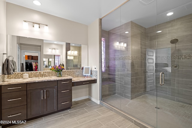 bathroom with vanity and a shower with shower door