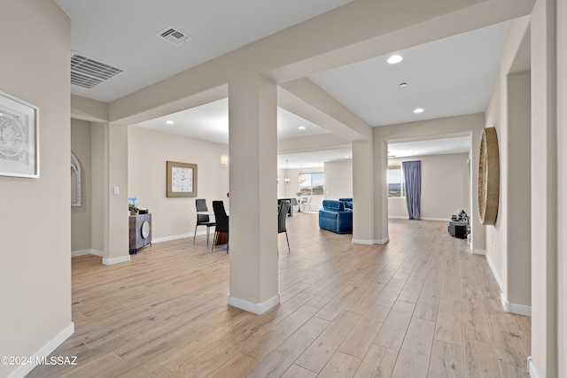 interior space with light hardwood / wood-style floors and a chandelier