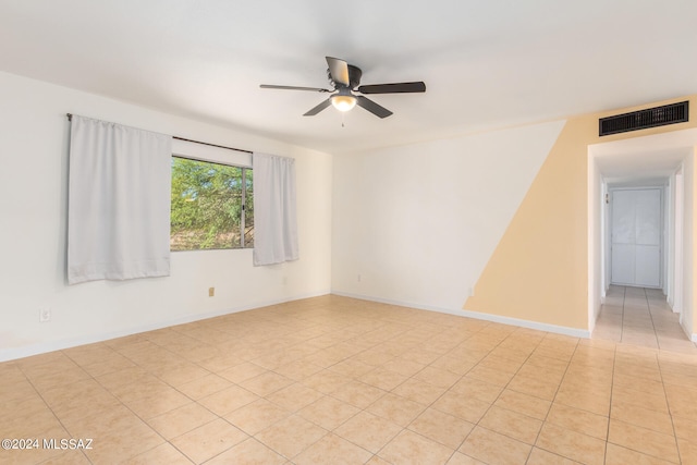 spare room with light tile patterned flooring and ceiling fan