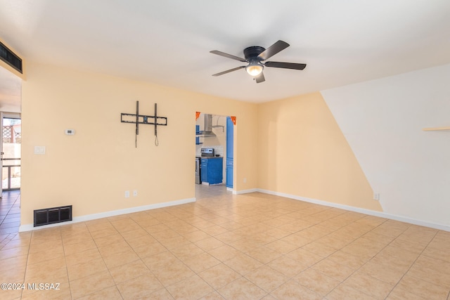 spare room with light tile patterned floors and ceiling fan