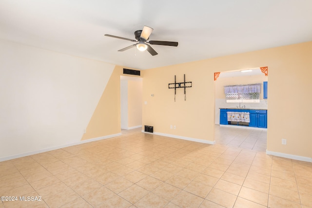 empty room with light tile patterned flooring and ceiling fan