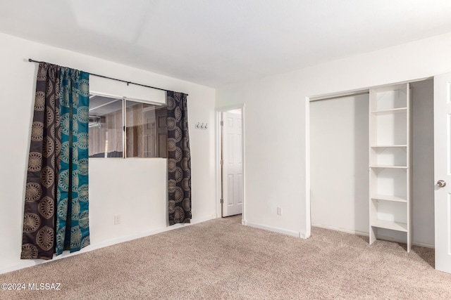 unfurnished bedroom with carpet flooring and a closet