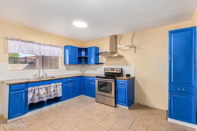 kitchen with wall chimney exhaust hood, stainless steel electric range, sink, and blue cabinets