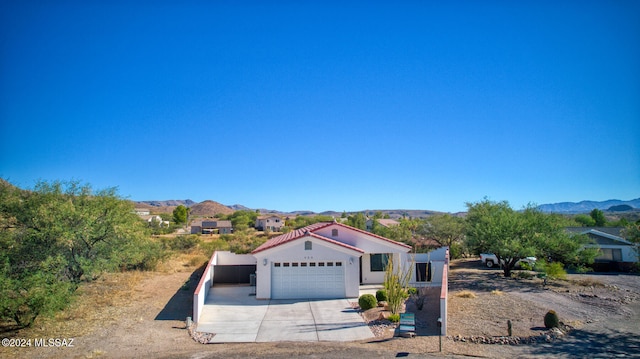 view of front facade with a mountain view and a garage