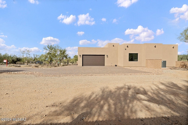 back of property featuring a garage