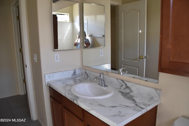 bathroom with tile patterned flooring and vanity