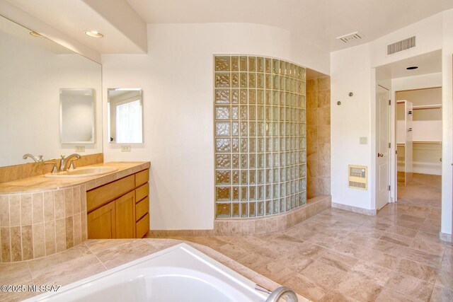 bathroom with walk in shower and vanity