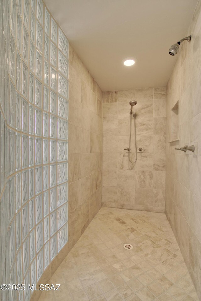 bathroom with a tile shower