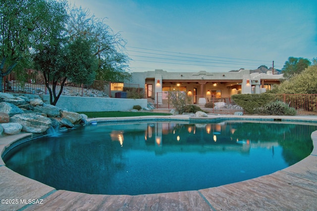 view of pool at dusk