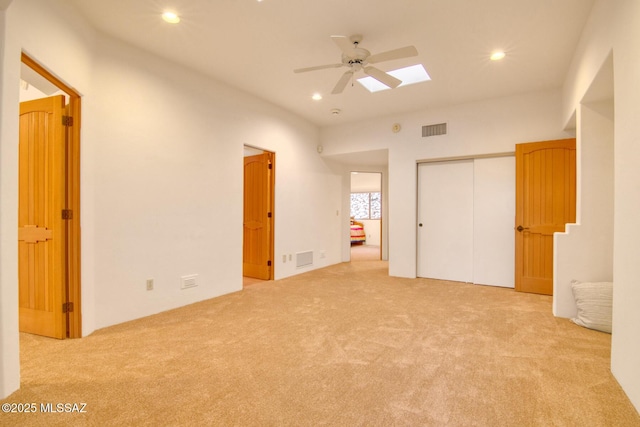 bedroom with ceiling fan, light colored carpet, and built in desk