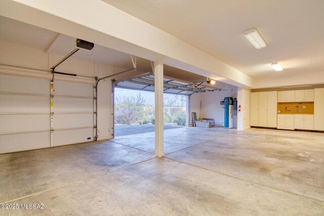 garage with water heater and a garage door opener