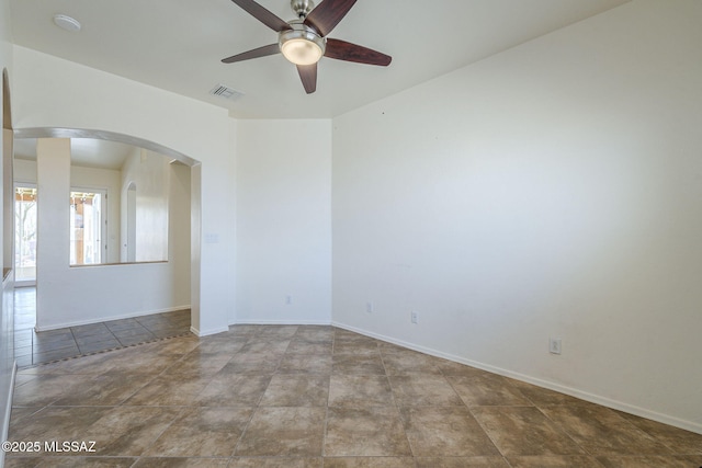 1888 Circulo Guatemala, Rio Rico, AZ 85648 - empty room with ceiling fan, arched walkways, and baseboards