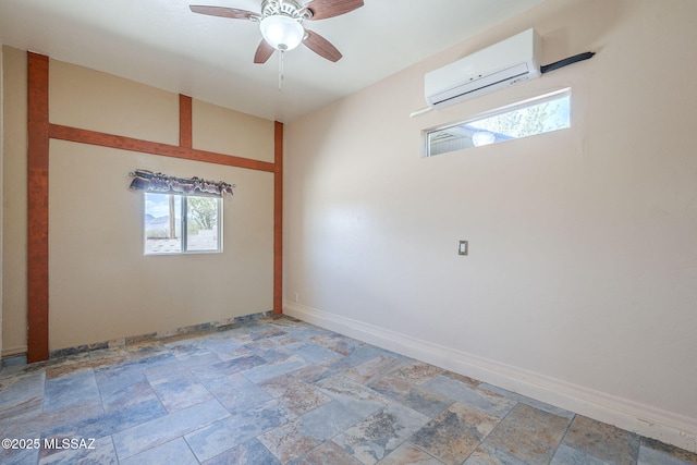 1888 Circulo Guatemala, Rio Rico, AZ 85648 - unfurnished room with a wall mounted air conditioner, a ceiling fan, light stone finish floors, and baseboards