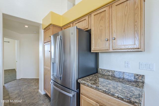 1888 Circulo Guatemala, Rio Rico, AZ 85648 - kitchen featuring stainless steel fridge, light brown cabinets, dark stone countertops, and baseboards